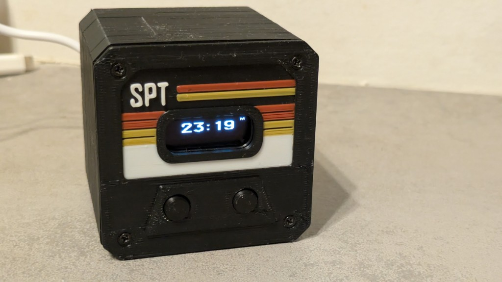 Presence Hub on a desk — OLED clock, retro faceplate, USB power